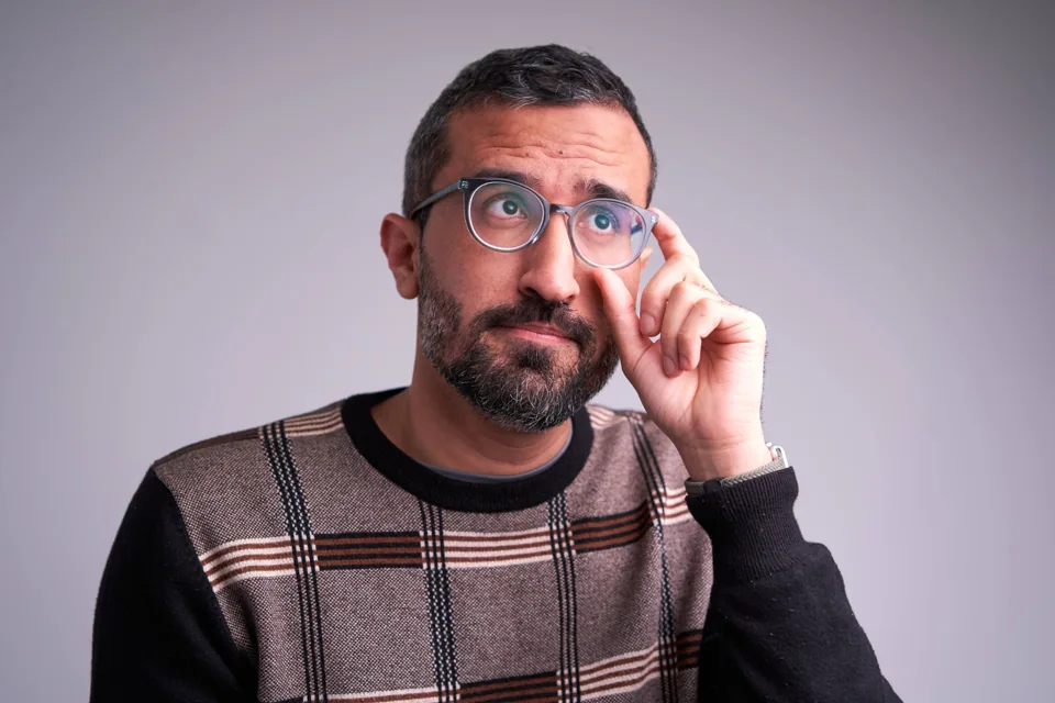 Tahir adjusting his glasses